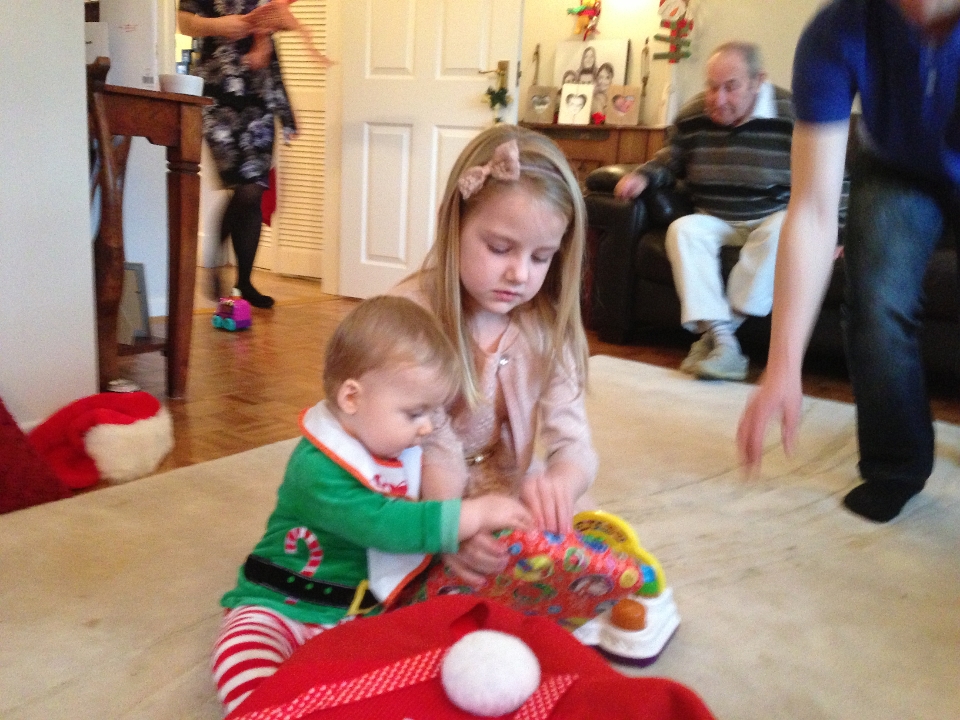 2012-12-25 13.56.47 Amelie helping Archie open his presents